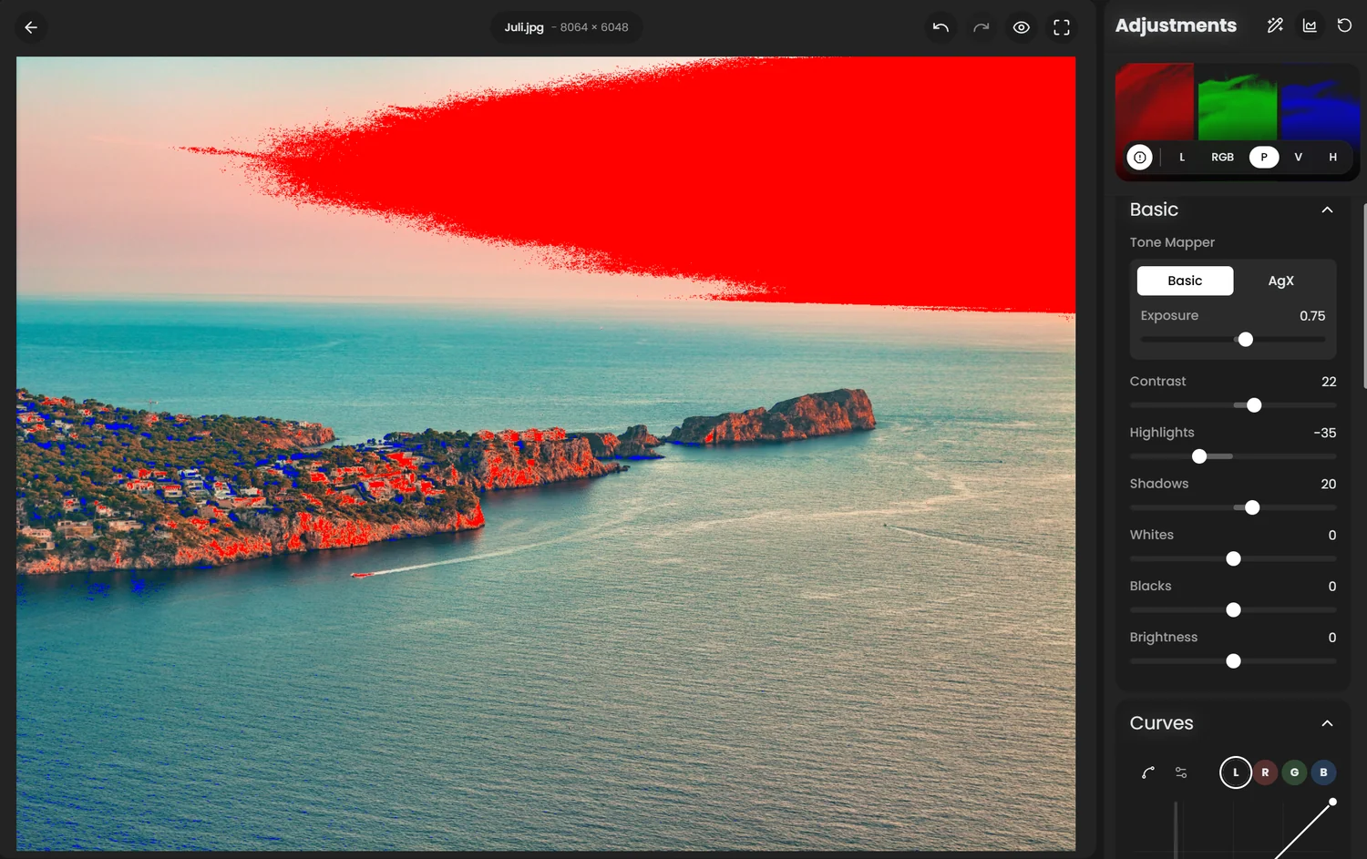 Clipping warnings on a coastal photo: the brightest part of the sky painted red and the darkest shadows painted blue